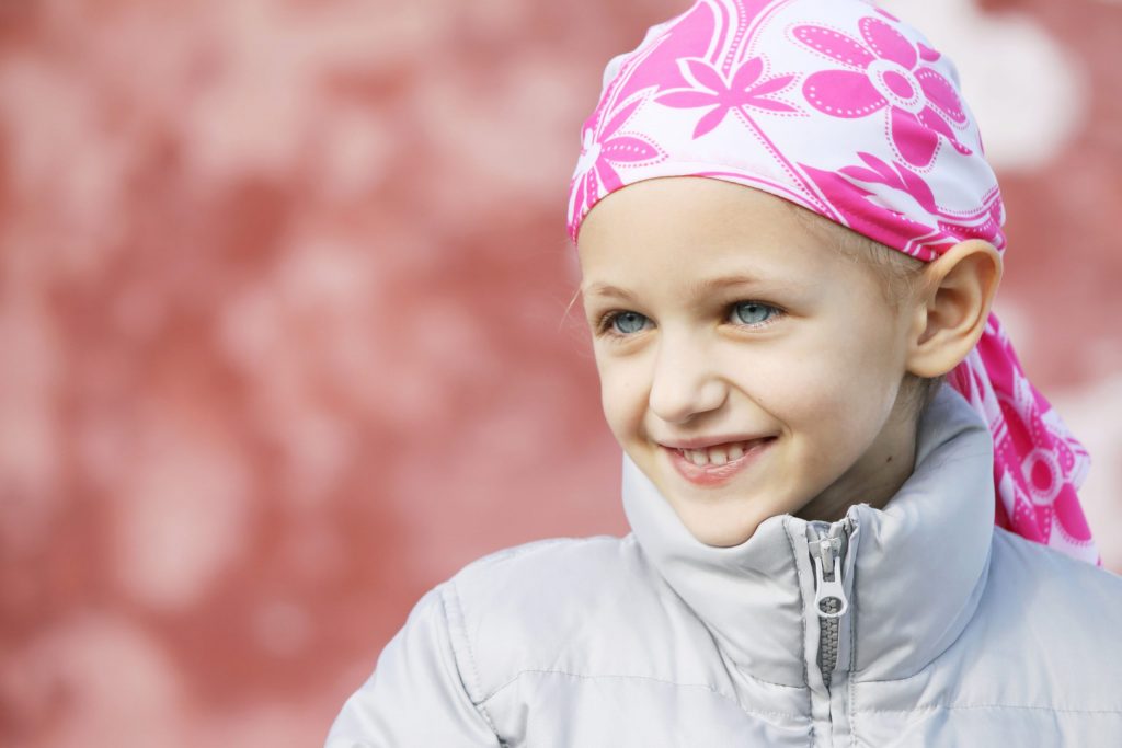 Beautiful caucasian girl wearing a head scarf due to hair loss from chemotherapy fighting cancer